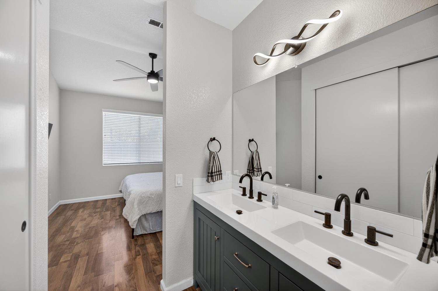 9365 Laguna Pointe Way Elk Grove, CA 95758 - Photo 18 of 24 a bathroom with a sink and a mirror