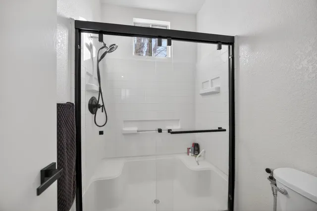 a bathroom with a sink toilet and shower