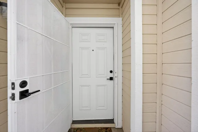 a living room with furniture and a flat screen tv with wooden floor