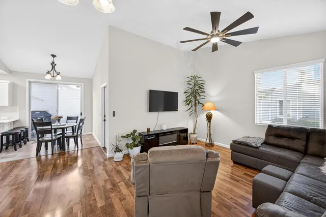 a living room with furniture and a chandelier