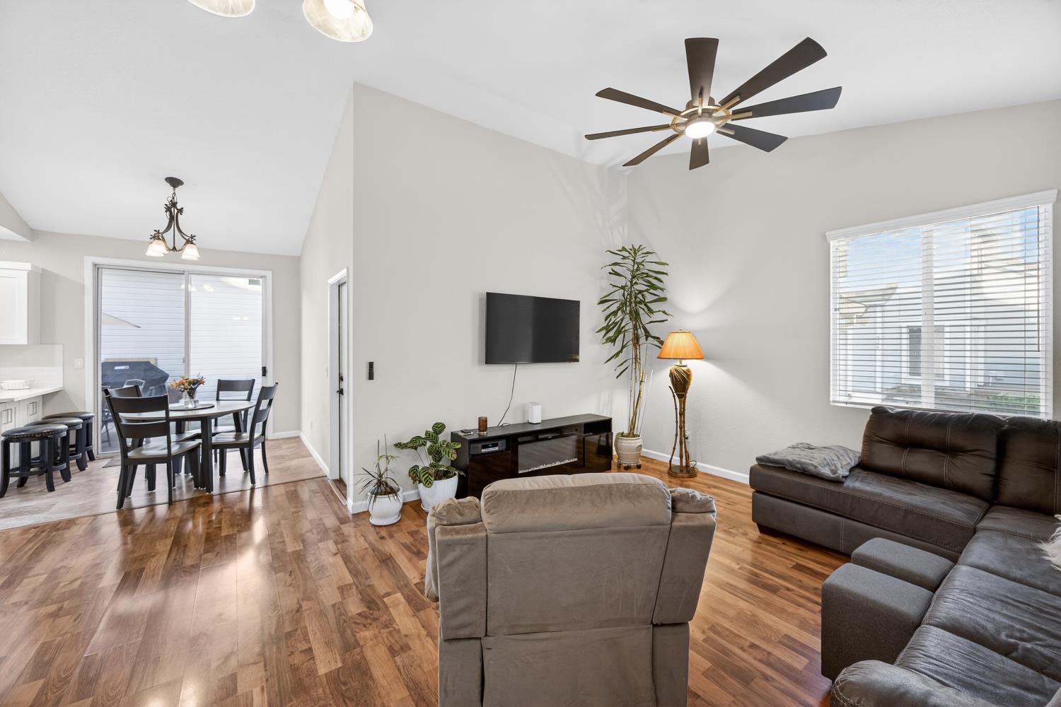 9365 Laguna Pointe Way Elk Grove, CA 95758 - Photo 4 of 24 a living room with furniture and a flat screen tv with wooden floor