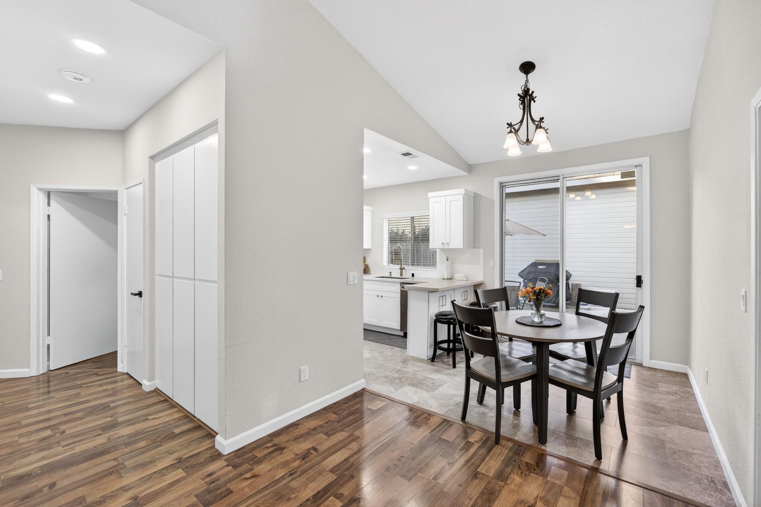 9365 Laguna Pointe Way Elk Grove, CA 95758 - Photo 7 of 24 a view of a dining room with furniture and wooden floor