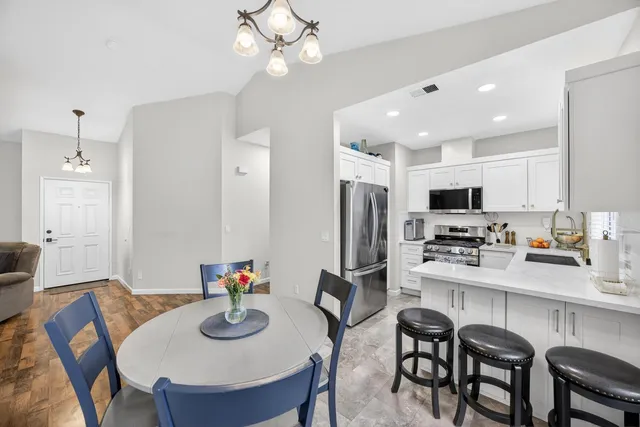 a kitchen with cabinets stainless steel appliances and a sink