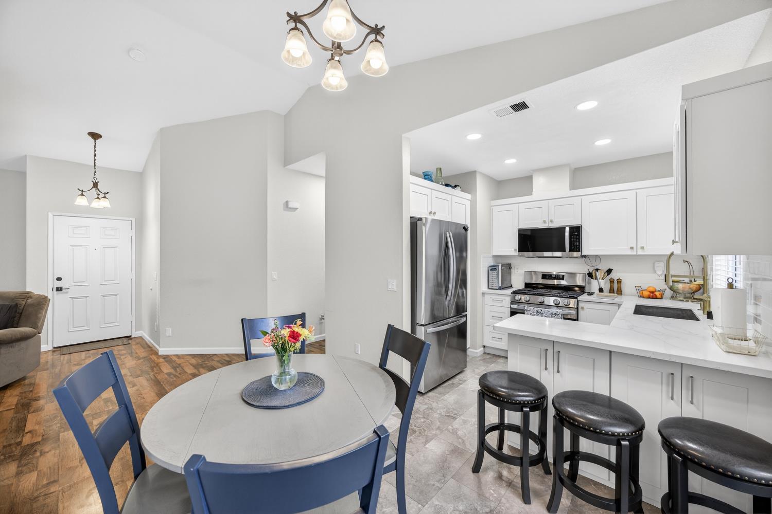 9365 Laguna Pointe Way Elk Grove, CA 95758 - Photo 10 of 24 a kitchen with stainless steel appliances granite countertop a dining table and chairs