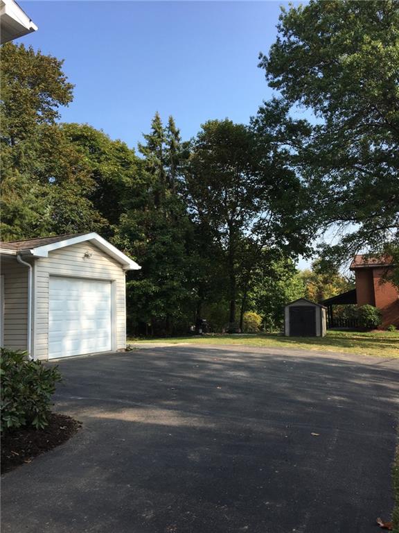 2904 Brodhead Road Aliquippa, PA 15001 - Photo 18 of 20 Rear of property showing Detached Garage. Additional parking pad is just beyond. Shed is included. Fire pit area is ready for those cool summer nights.
