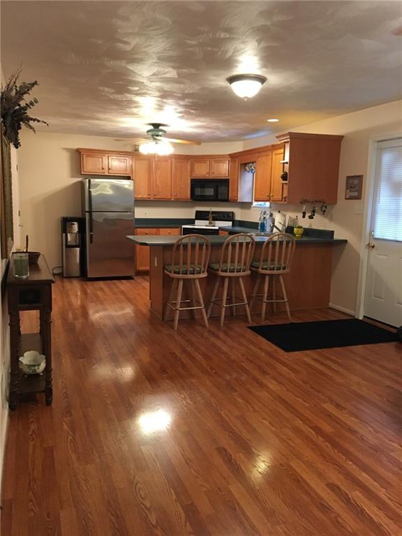 2904 Brodhead Road Aliquippa, PA 15001 - Photo 5 of 20 KITCHEN 13X12 Open Kitchen and Family Room. Refridgerator, Range, Dishwasher and built in Microwave is included. Door on right leads to the covered patio. Bar area is a great place for breakfast.