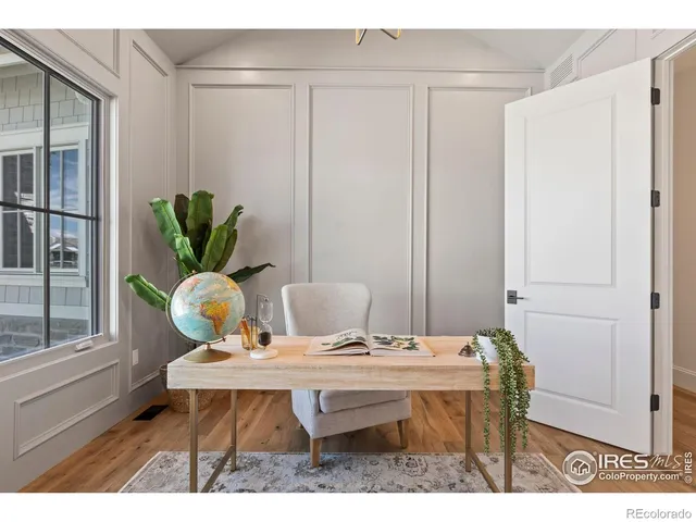 a living room with furniture a rug entryway and a large window