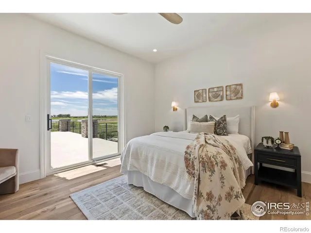 a bathroom with a double vanity sink a large mirror and a bathtub