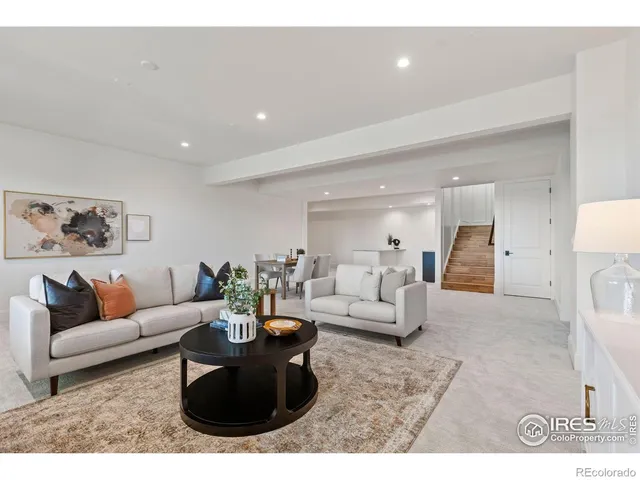 a living room with furniture and a dining table