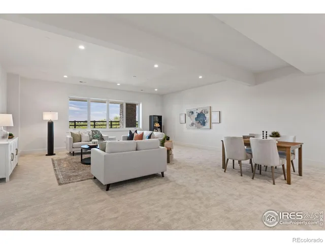 a view of an empty room with kitchen and furniture