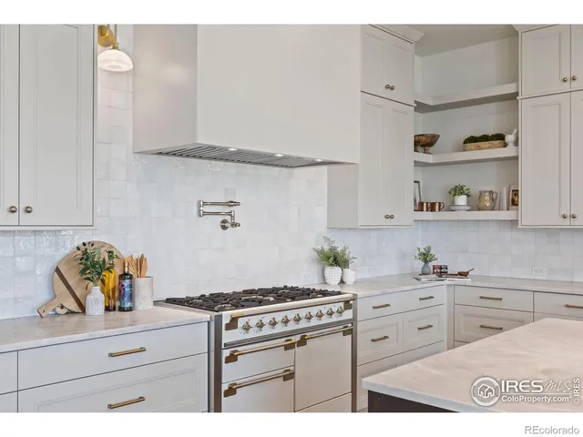 a kitchen with white cabinets and appliances
