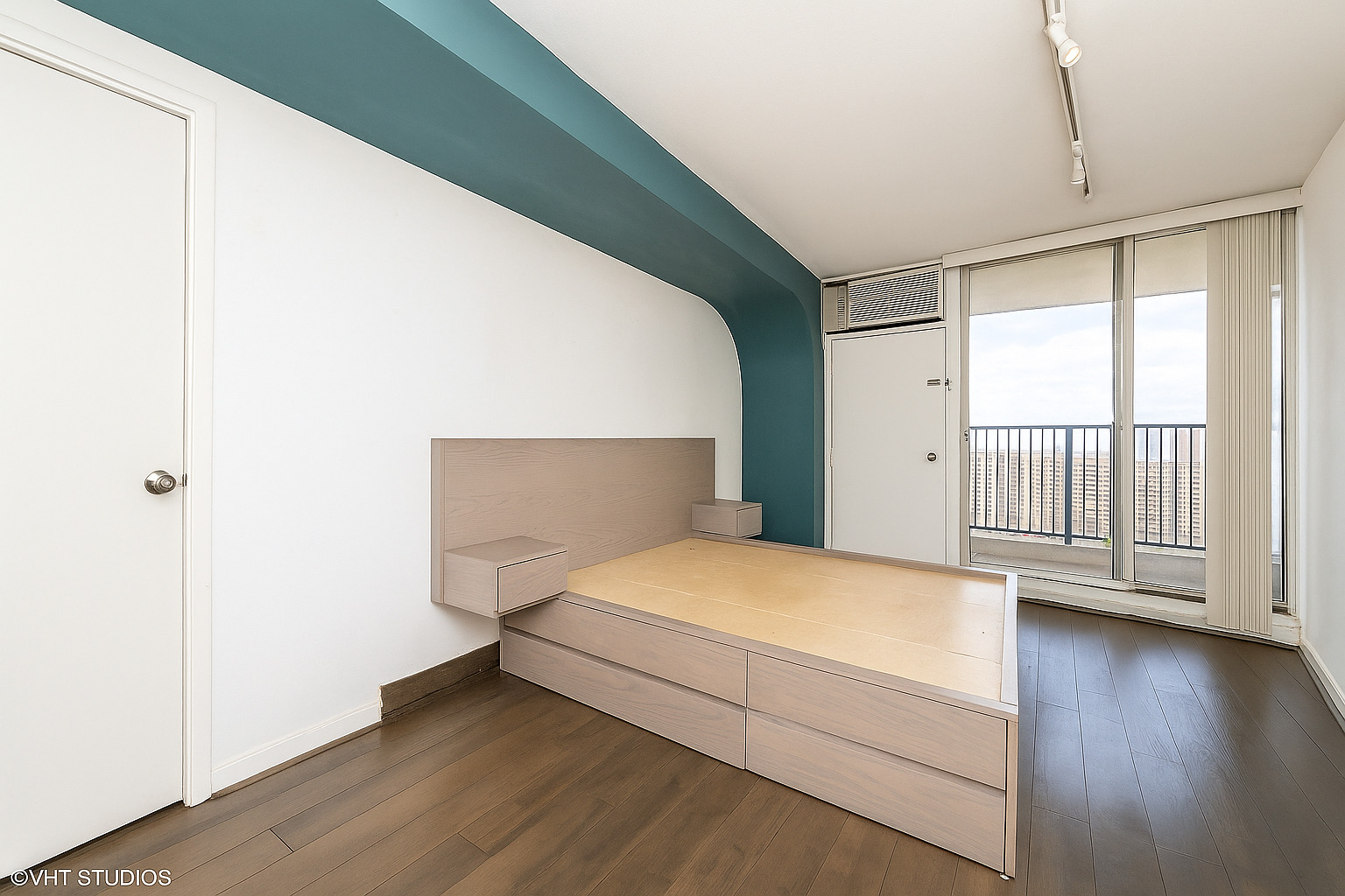 300 North State Street, Unit 5503 Chicago, IL 60654 - Photo 10 of 12 a bedroom with a bed and wooden floor