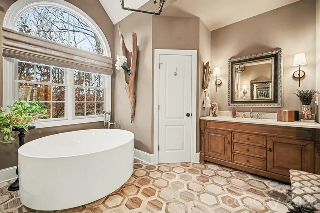 a spacious bathroom with a tub and a sink