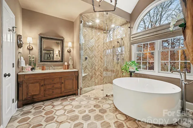 a spacious bathroom with a double vanity sink mirror and bathtub