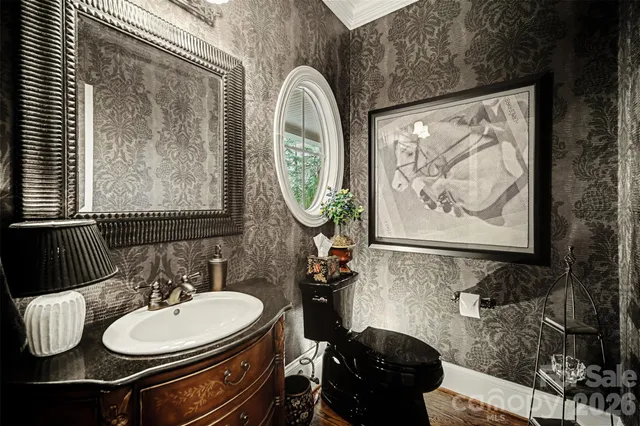 a bathroom with a sink mirror and vanity