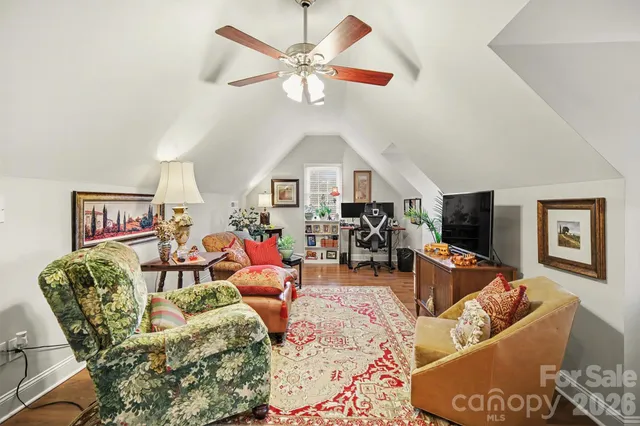 a living room with furniture a fireplace and a chandelier