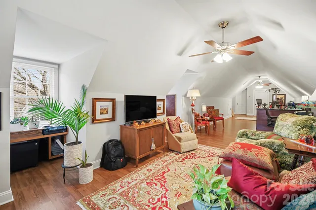 a living room with furniture a flat screen tv and a window