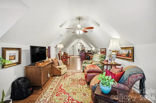 a living room with furniture fireplace and flat screen tv