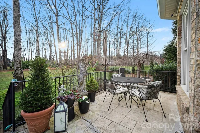 a view of a chairs and table in backyard