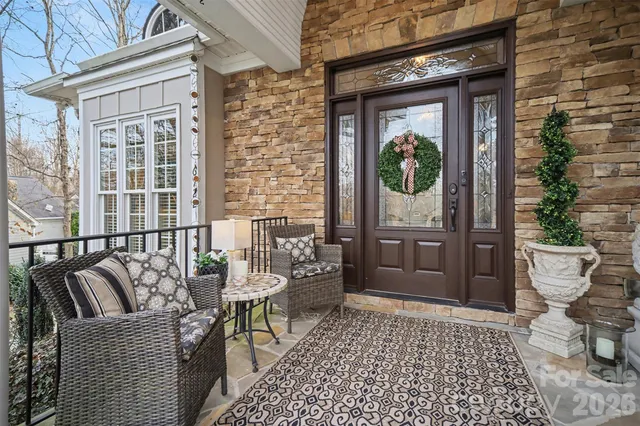 a balcony with furniture and a potted plant