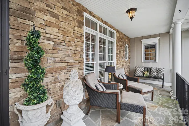 a balcony with furniture and flowers