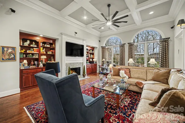 a living room with fireplace furniture and a flat screen tv