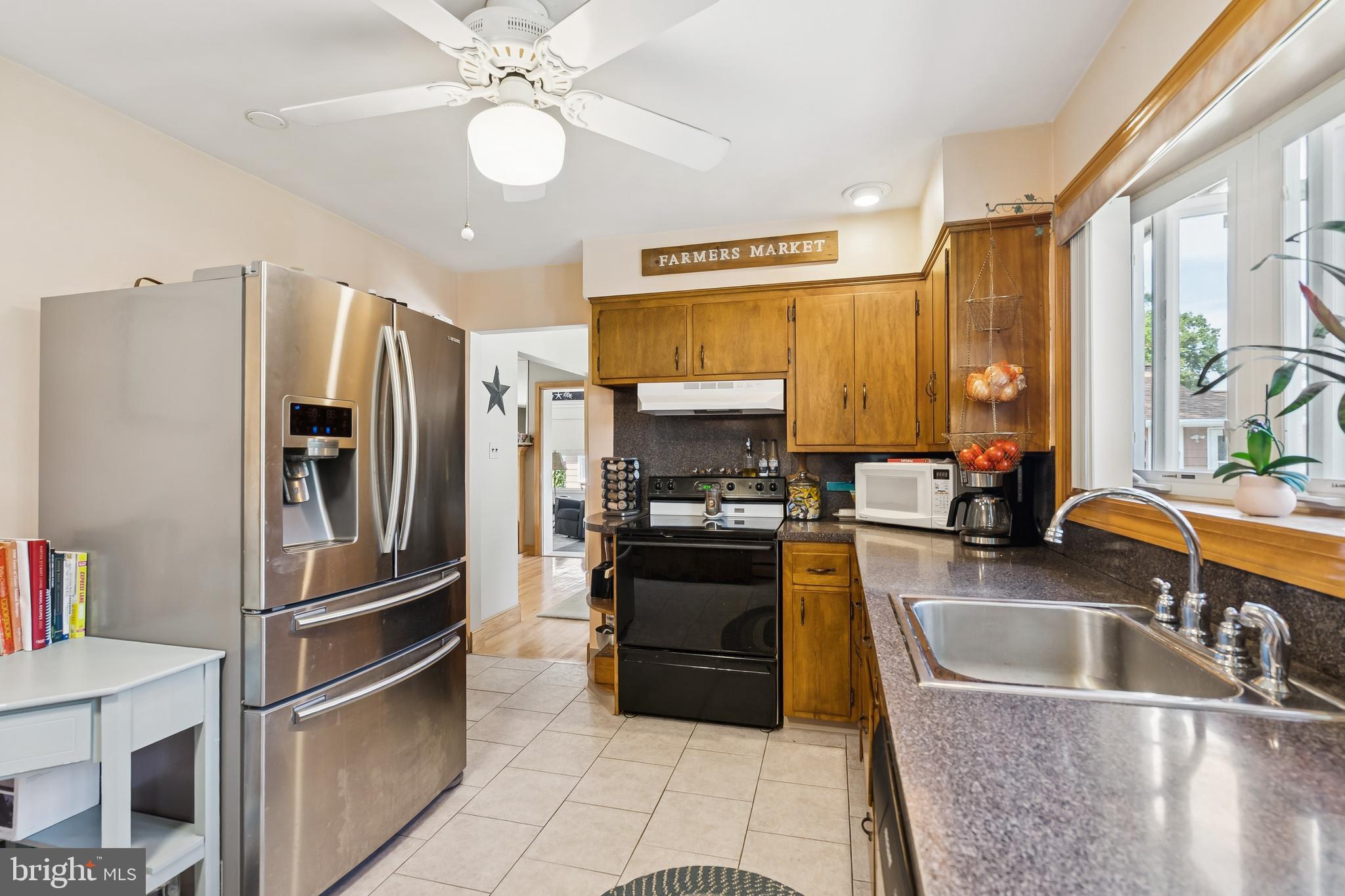 360 Station Road Roebling, NJ 08554 - Photo 10 of 28 a kitchen with a refrigerator a sink and a stove top oven with wooden floor