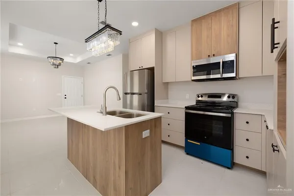 a kitchen with stainless steel appliances a sink stove and refrigerator