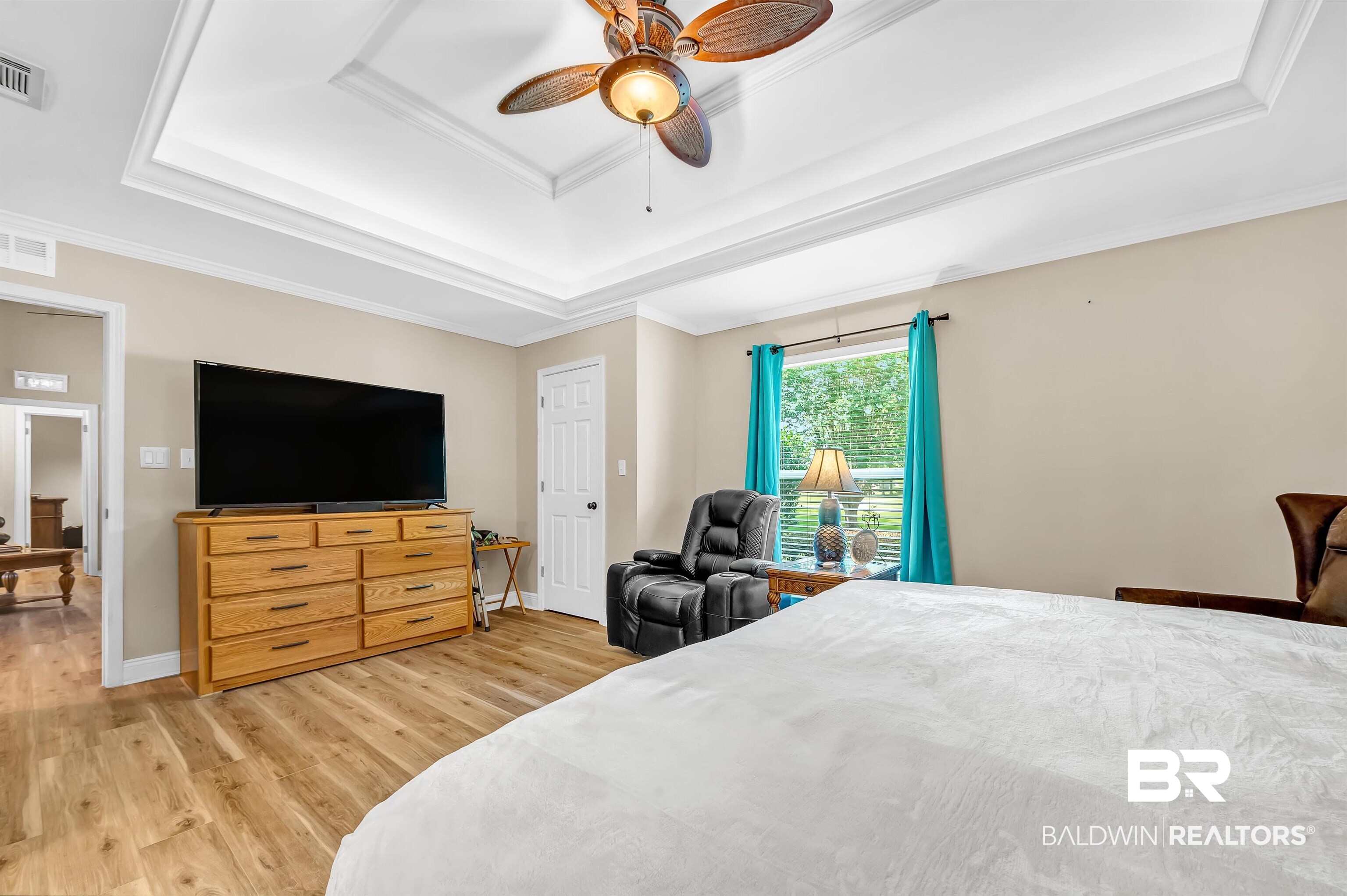 24551 Wolf Bay Drive Foley, AL 36535 - Photo 36 of 59 Bedroom with a tray ceiling, light wood-style floors, crown molding, and a ceiling fan