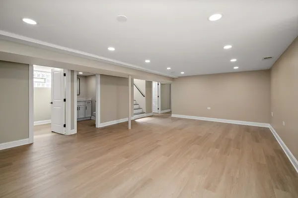 an empty room with wooden floor and closet area