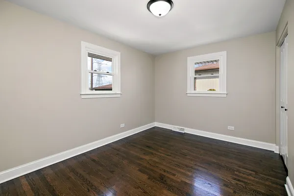 a view of a room with wooden floor and window