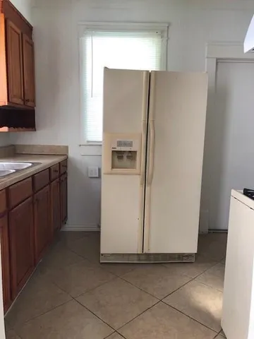 a white refrigerator freezer sitting in a kitchen