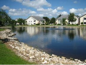 2058 Rookery Bay Drive, Unit 2304 Naples, FL 34114 - Photo 1 of 1 a view of a lake with a building in the background