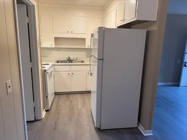 a kitchen with stainless steel appliances a refrigerator and a stove top oven