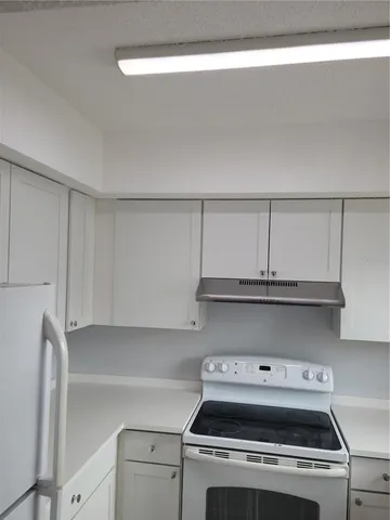 a stove top oven sitting inside of a kitchen