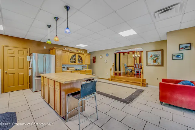 a kitchen with stainless steel appliances granite countertop a sink and a refrigerator