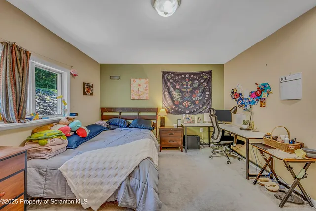 a bedroom with furniture and a window