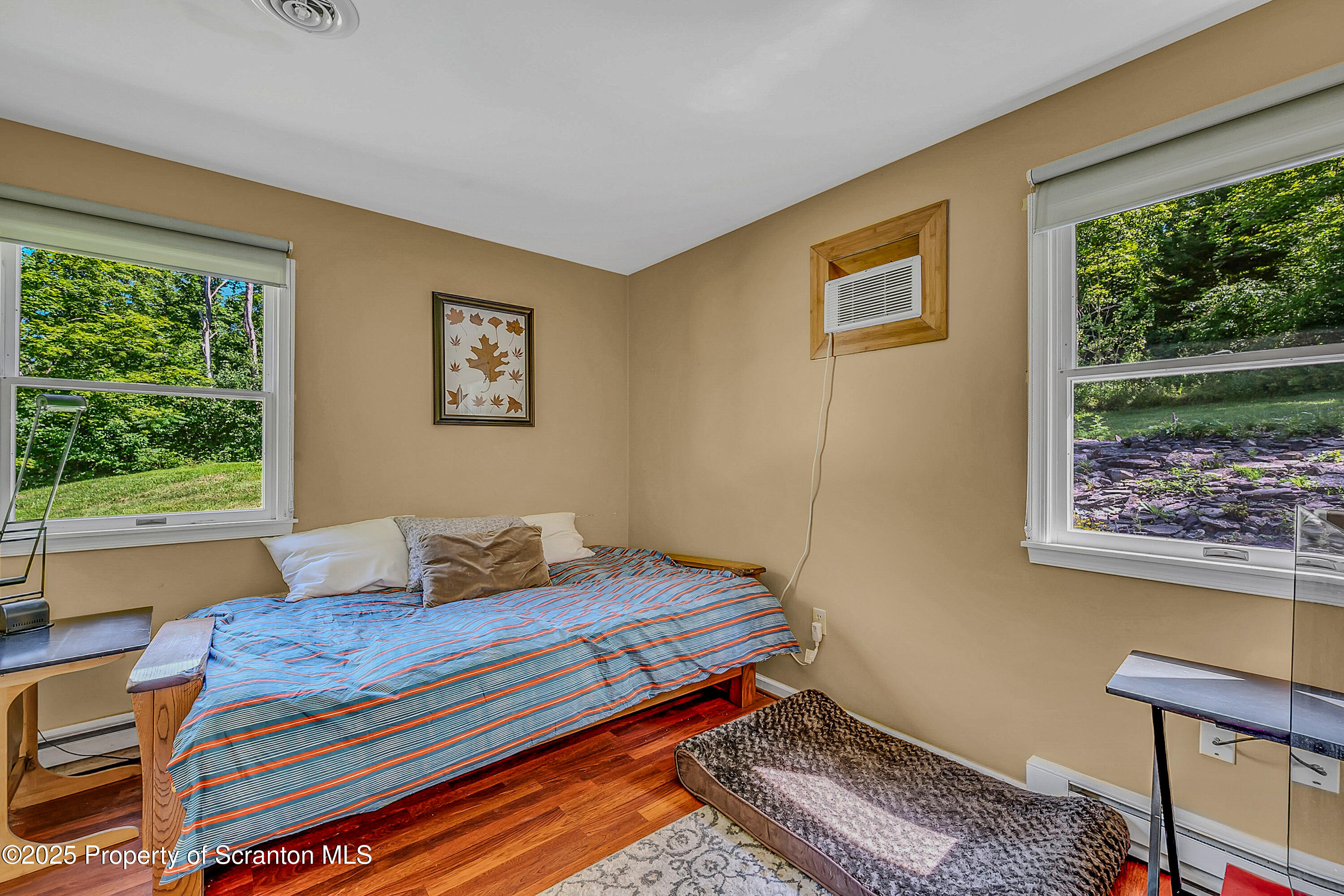 831 Montdale Road Scott Township, PA 18447 - Photo 25 of 46 a bedroom with a bed and wooden floor