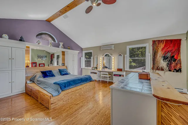 a living room with furniture kitchen view and a large window