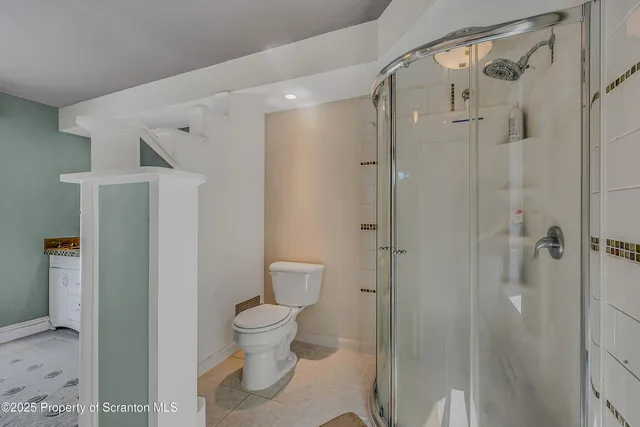 a bathroom with a toilet and a shower