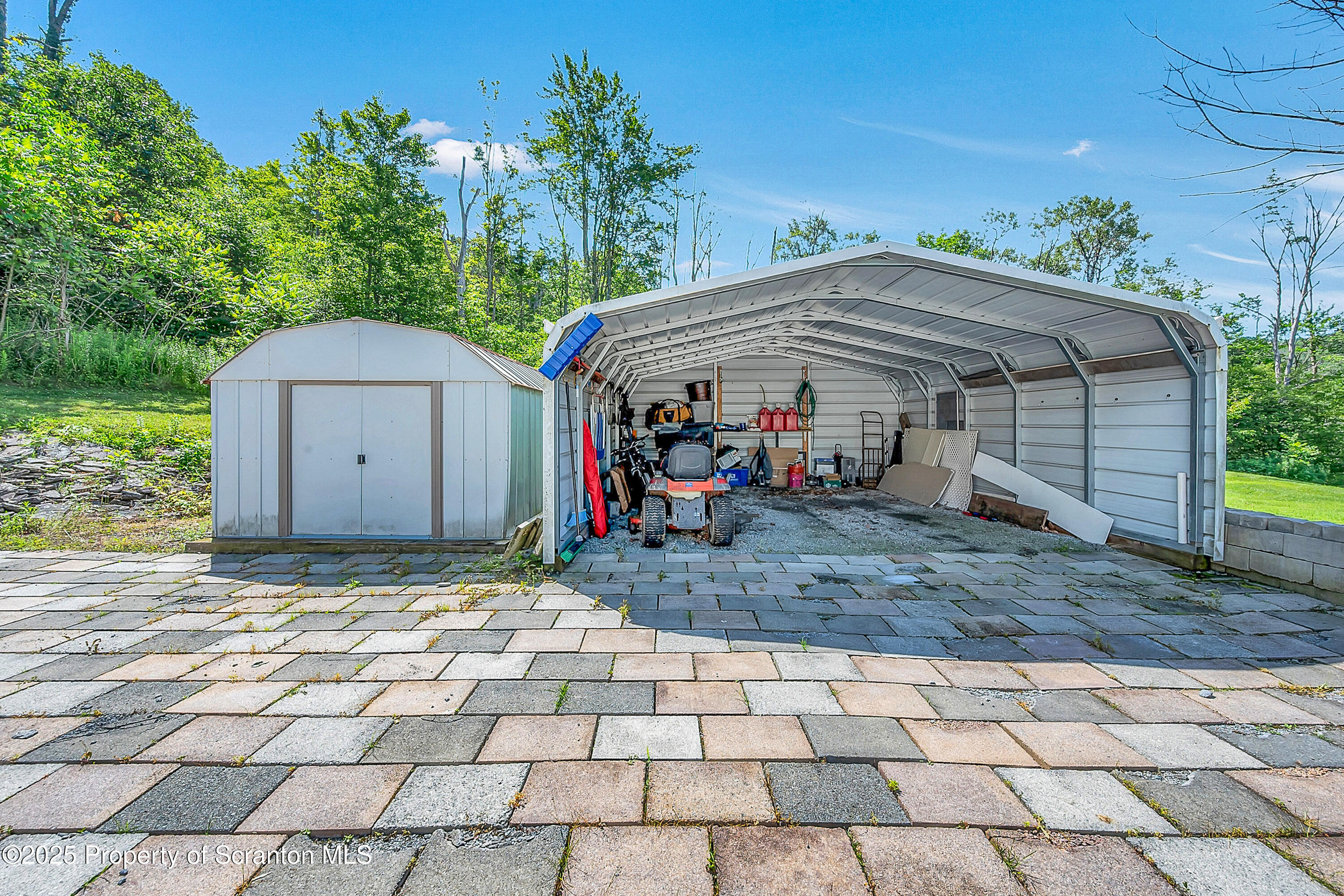 831 Montdale Road Scott Township, PA 18447 - Photo 38 of 46 a view of a house with a yard and potted plants