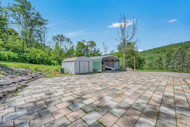 a front view of a house with a yard and trees