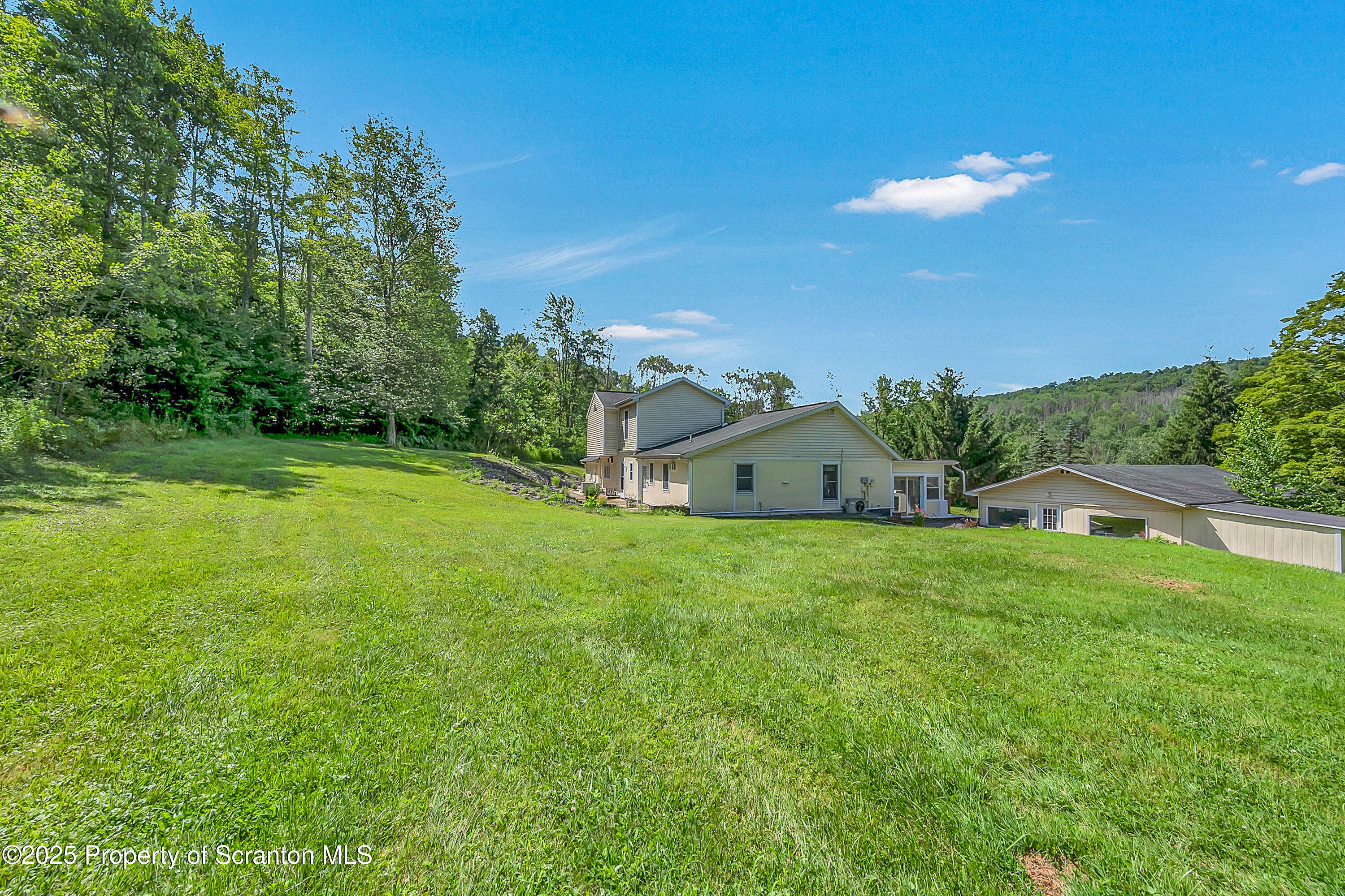 831 Montdale Road Scott Township, PA 18447 - Photo 4 of 46 a house view with a garden space
