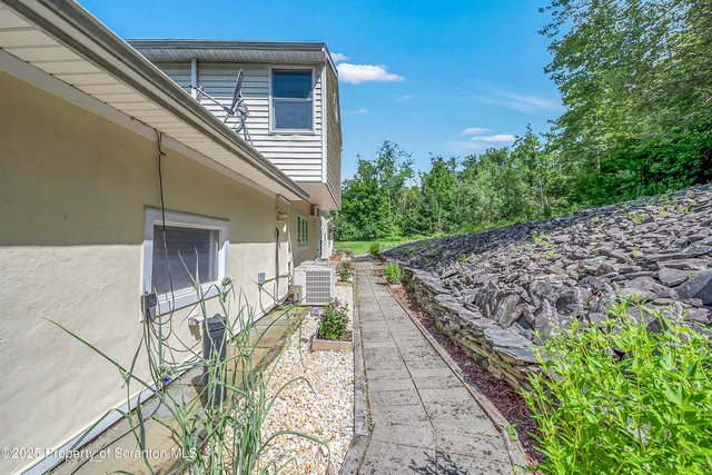 a balcony with chairs and wooden fence