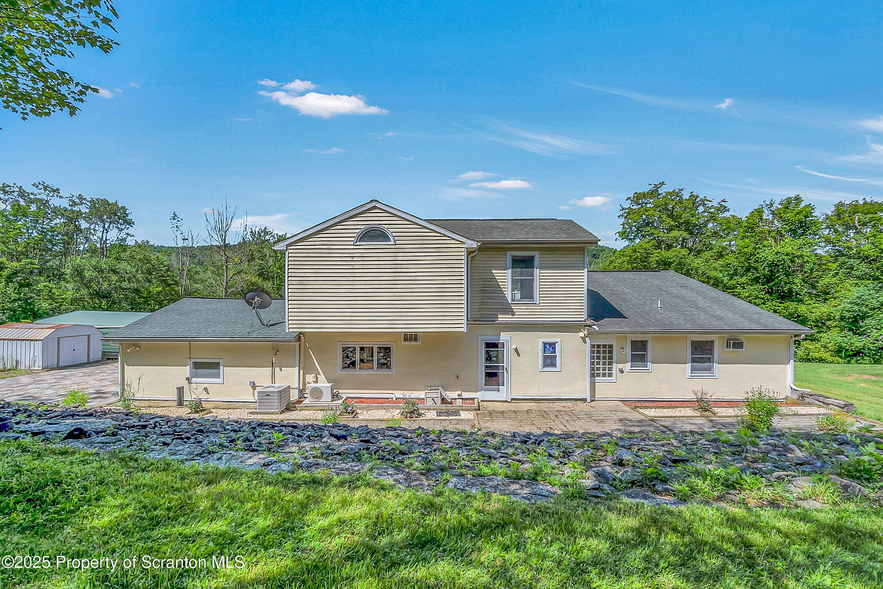 831 Montdale Road Scott Township, PA 18447 - Photo 43 of 46 a view of a house with a yard and plants