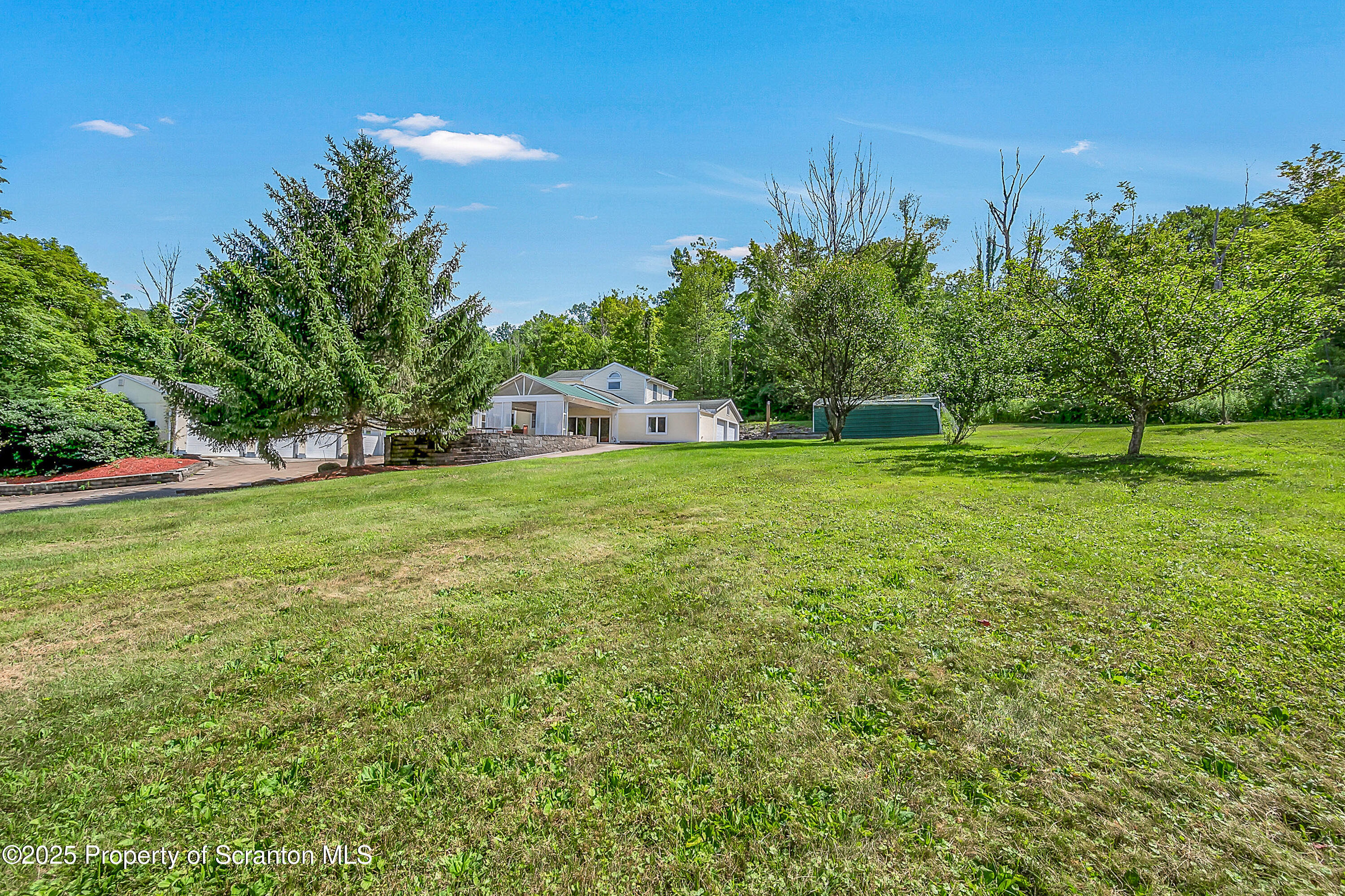 831 Montdale Road Scott Township, PA 18447 - Photo 8 of 46 a view of a field of grass and trees