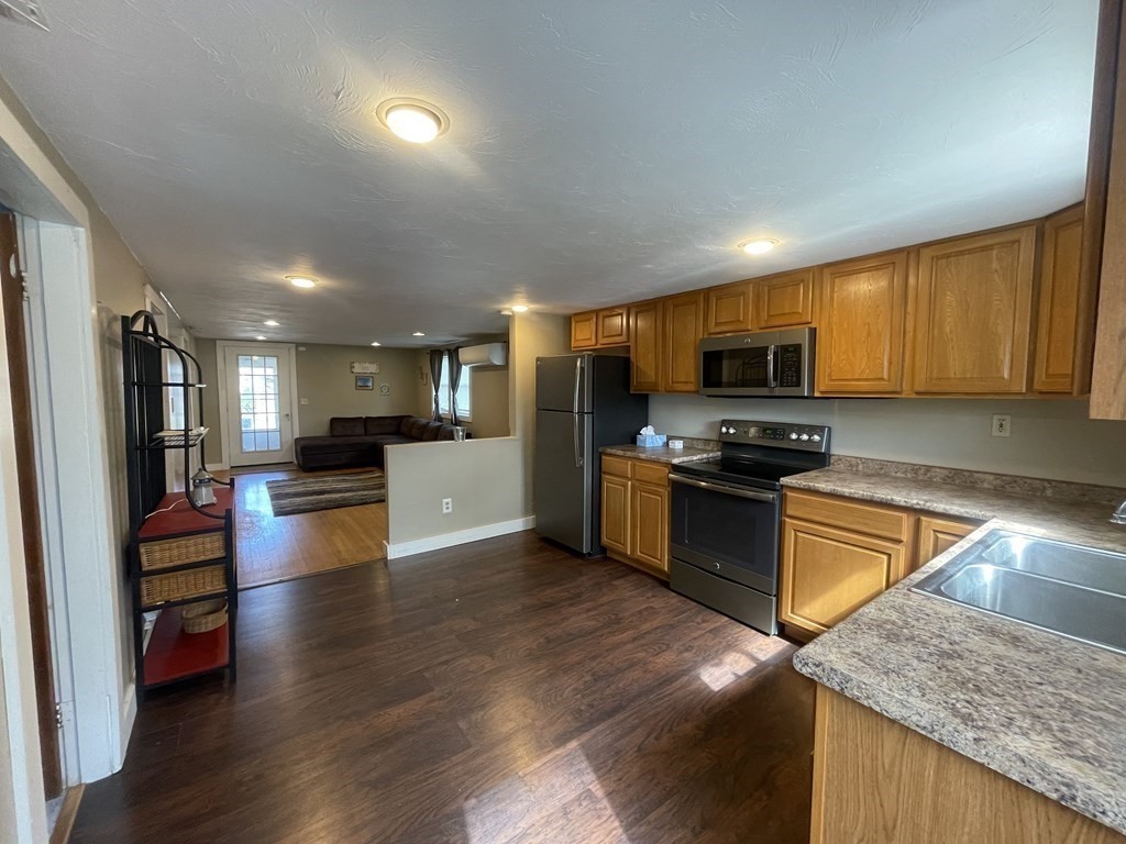 26 Wenonah Road Wareham, MA 02532 - Photo 5 of 21 a kitchen with stainless steel appliances granite countertop wooden cabinets a stove top oven a sink and dishwasher