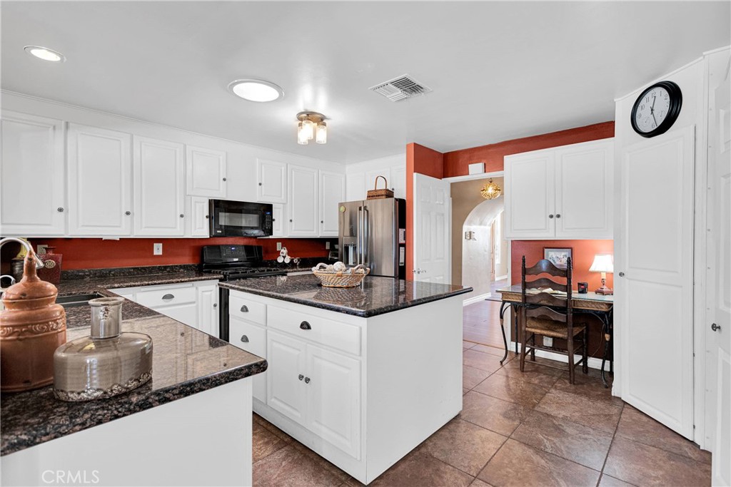 19955 Chickasaw Road Apple Valley, CA 92307 - Photo 18 of 60 a kitchen with stainless steel appliances granite countertop a stove and a sink
