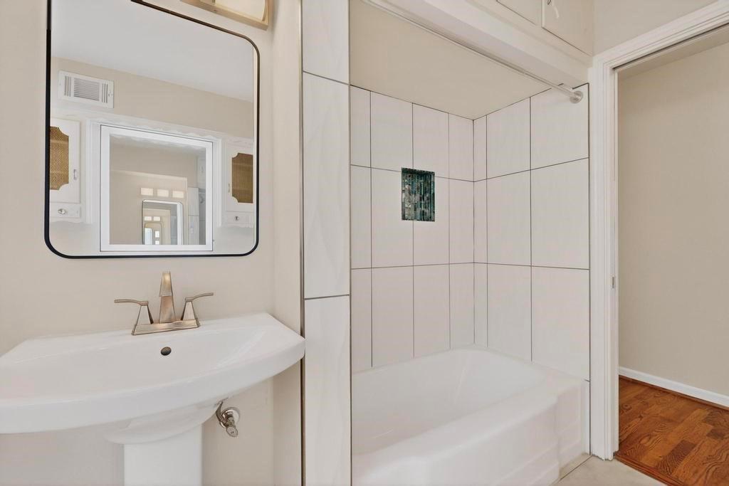 2120 Healey Drive Dallas, TX 75228 - Photo 25 of 39 a bathroom with a bathtub a sink and a mirror