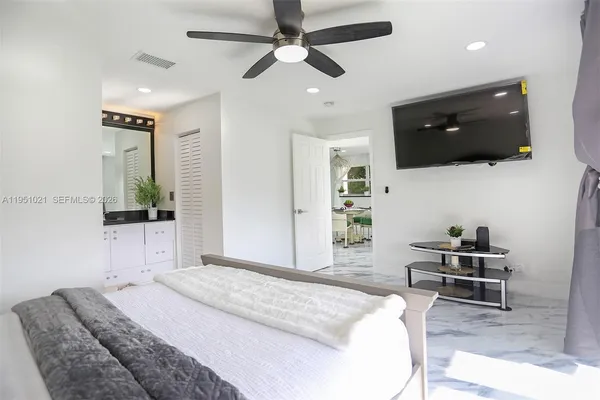 a bedroom with a bed and a television
